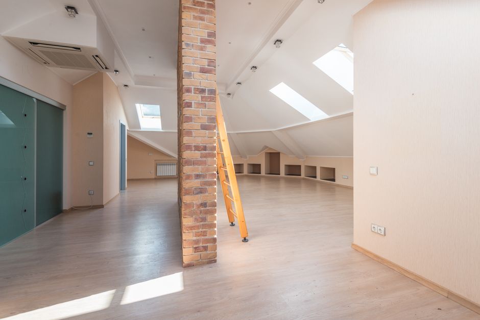 Professional applying spray foam home insulation in an attic